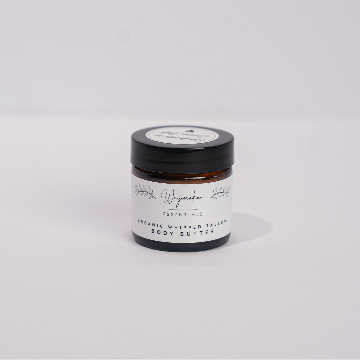 Small jar with a black lid on a white background - Organic tallow body butter
