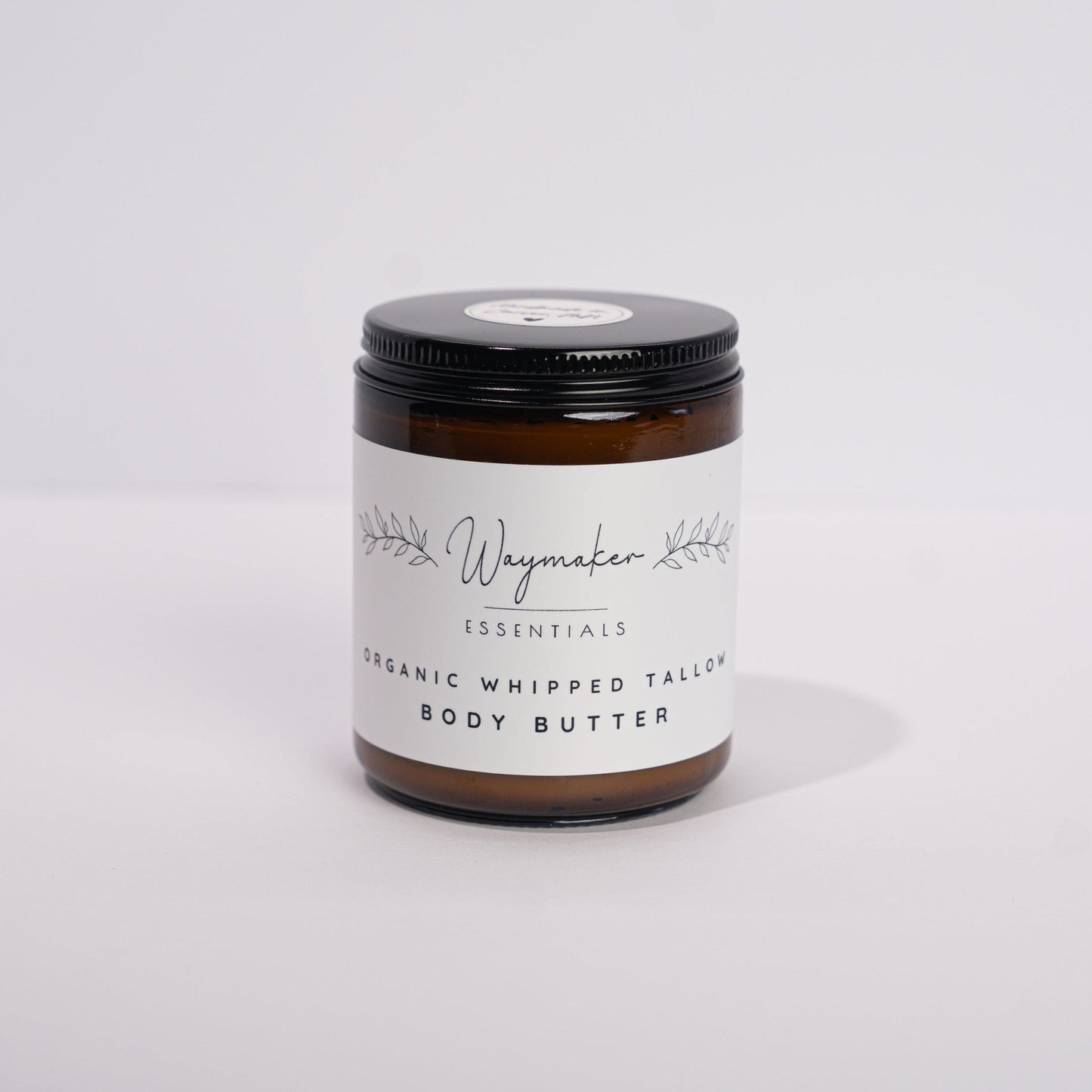 Jar of body butter on a white background