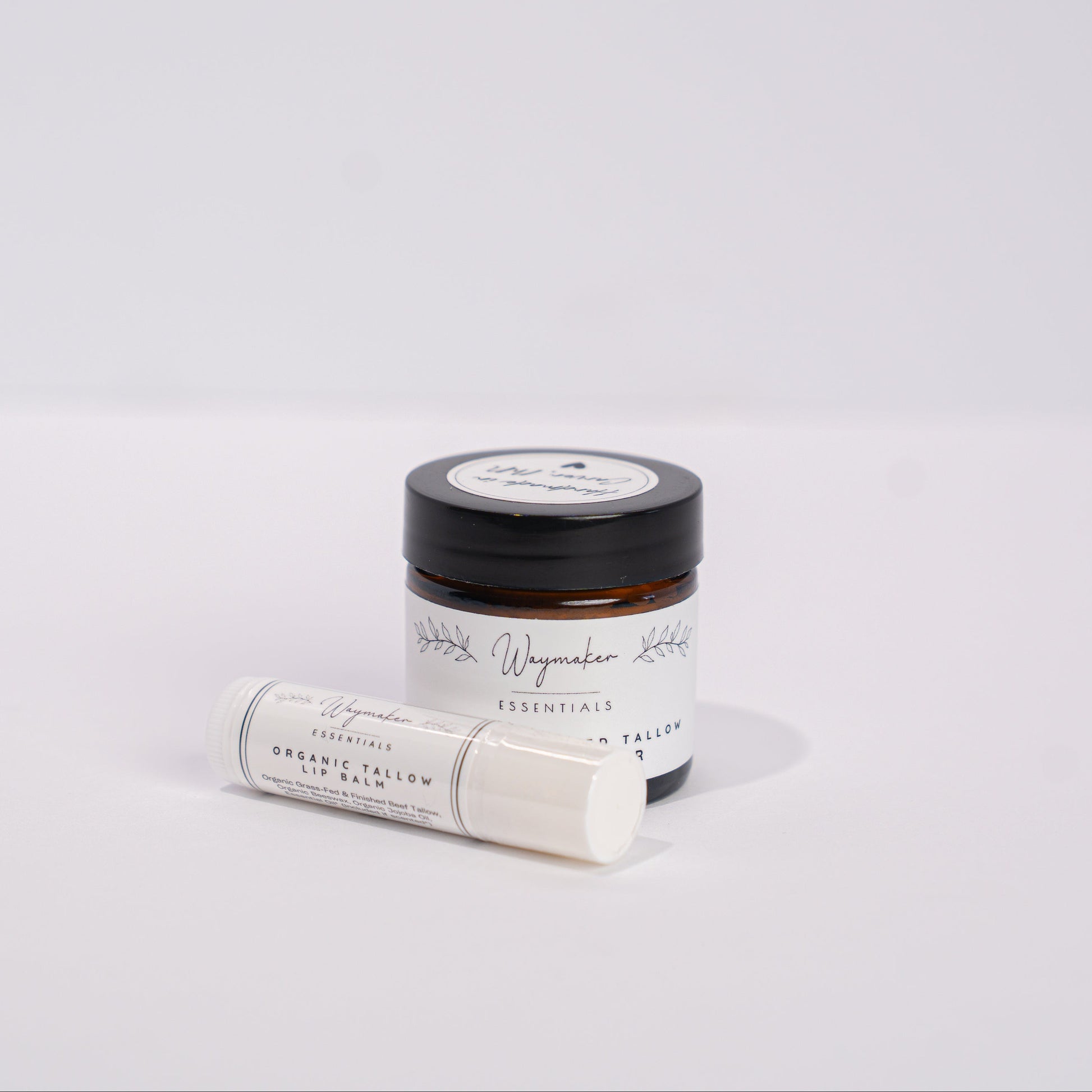 Small jar and roll-on bottle on a light gray background - Tallow Lip Balm, Organic Tallow