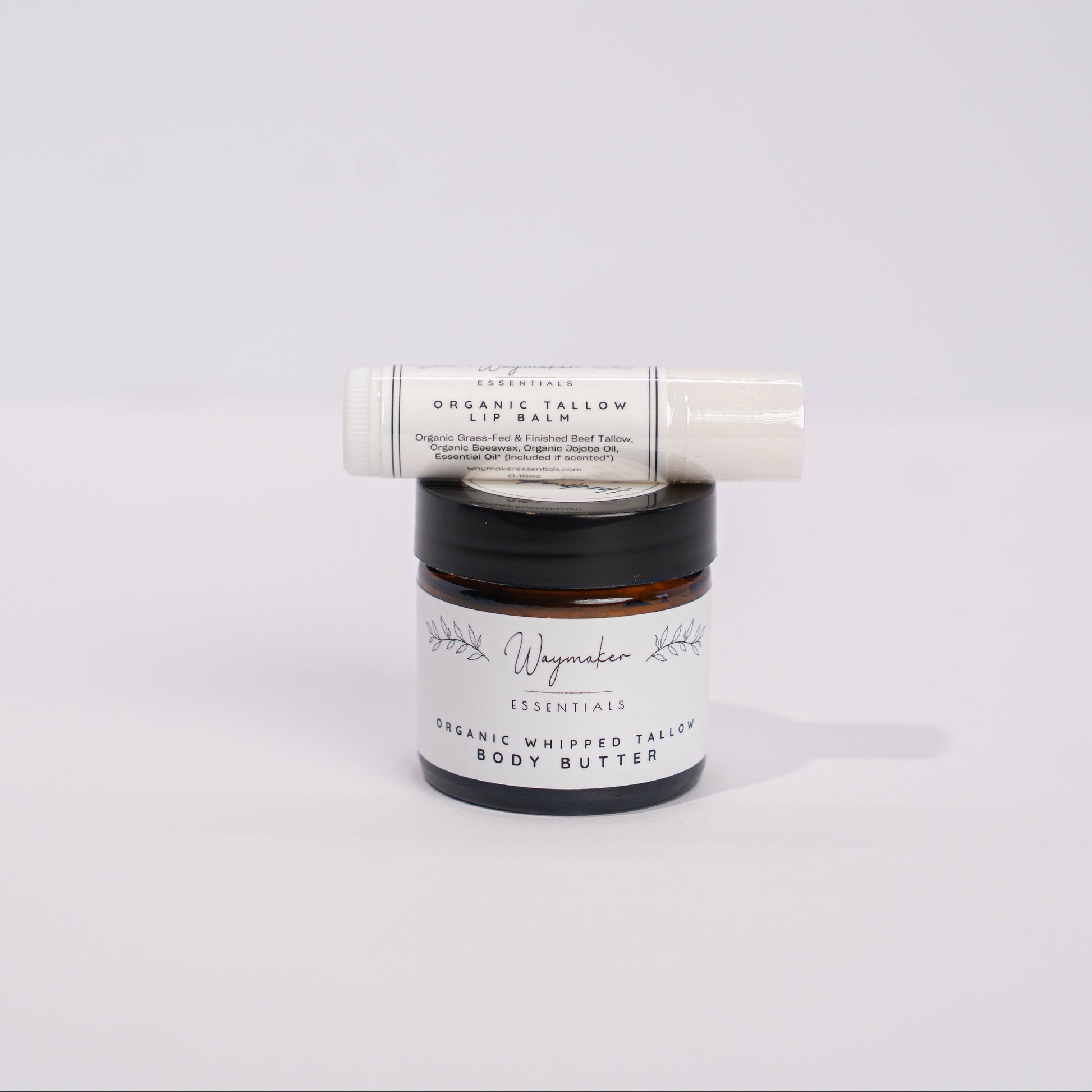 Two skincare products, a jar and a tube, on a light gray background - Tallow balm