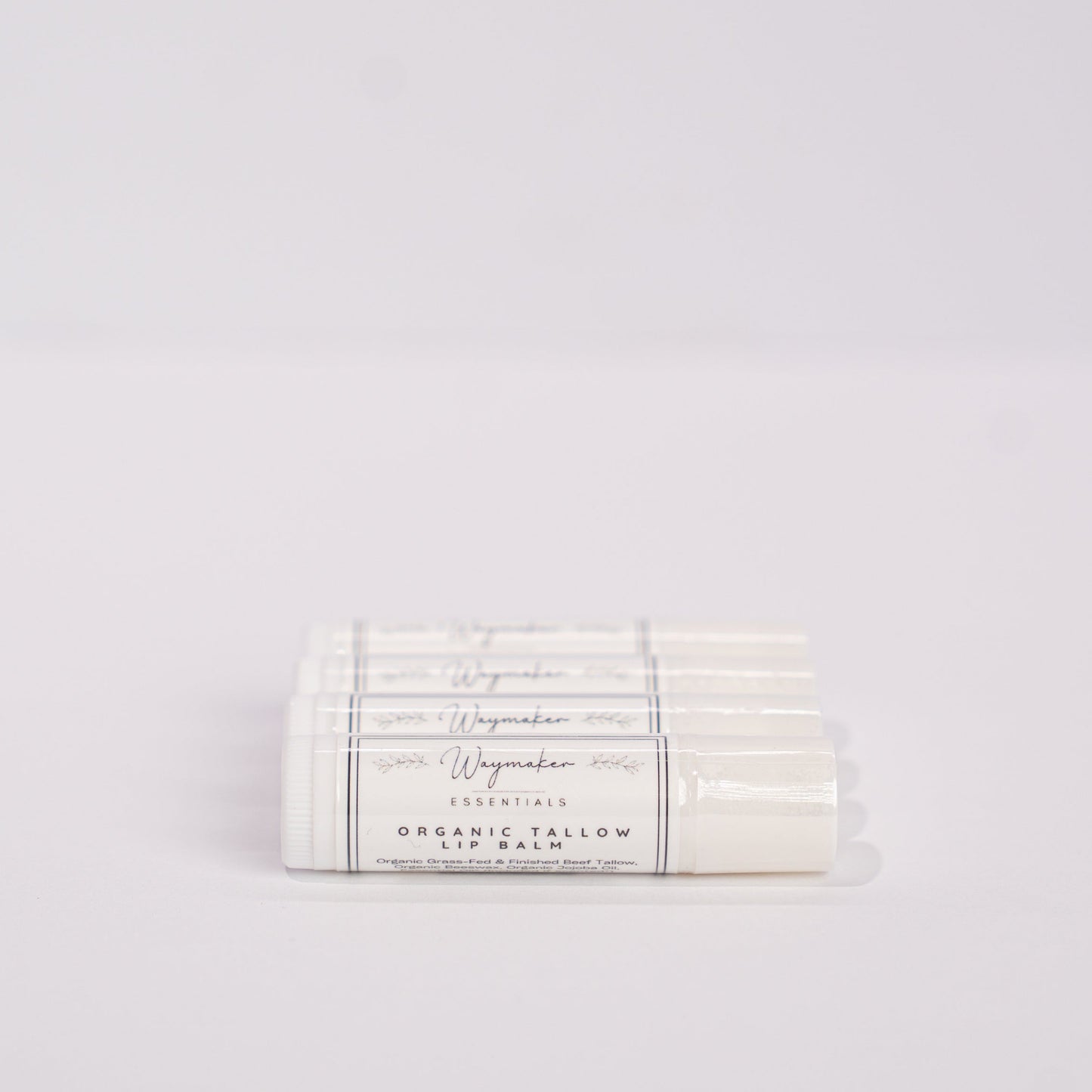 Lip balm packaging with visible branding on a light gray background - Organic Tallow lip balm