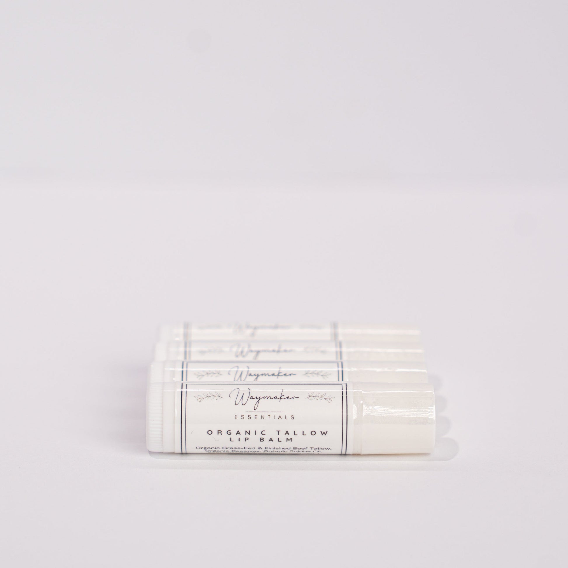 Lip balm packaging with visible branding on a light gray background - Organic Tallow lip balm