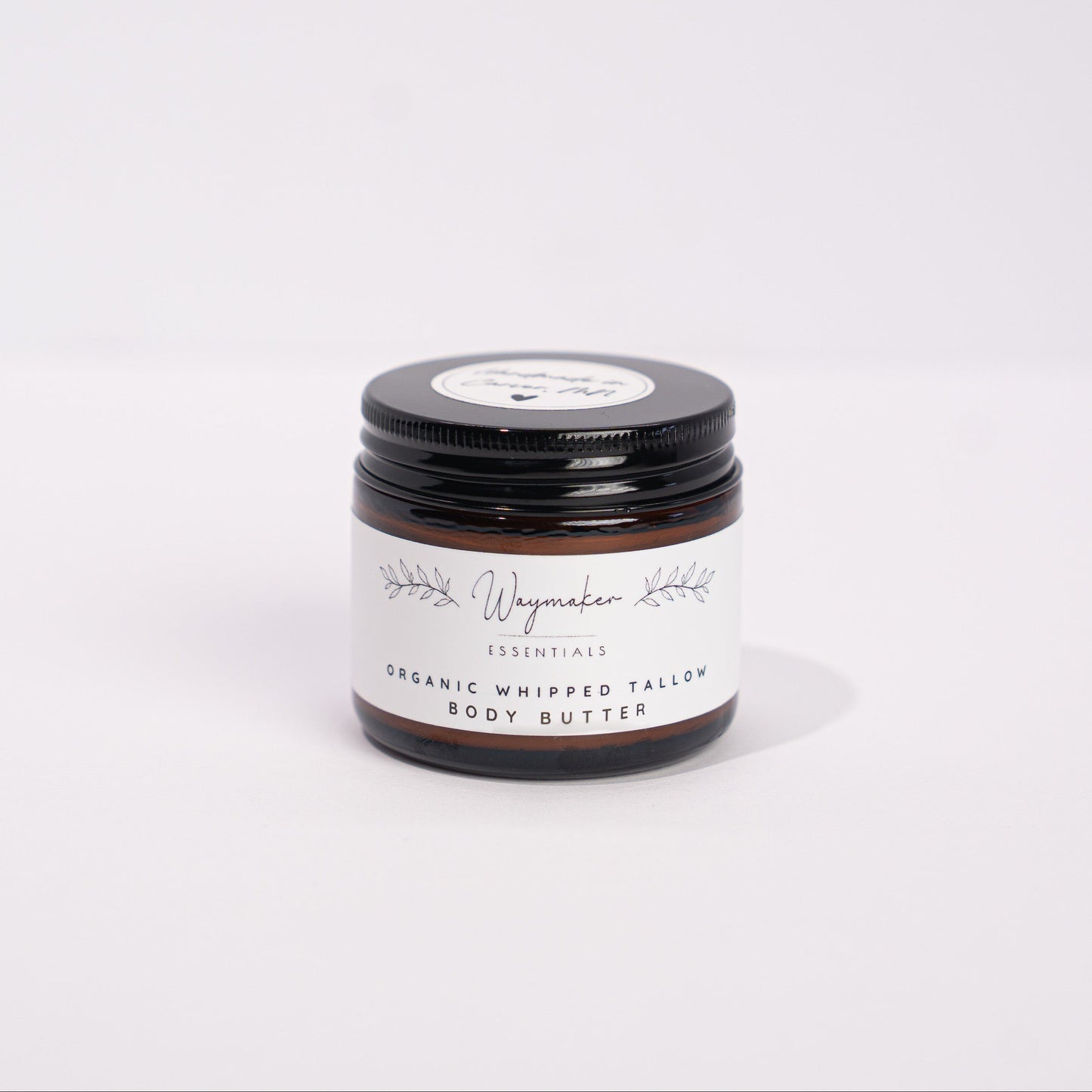 Small jar of organic whipped cream on a white background