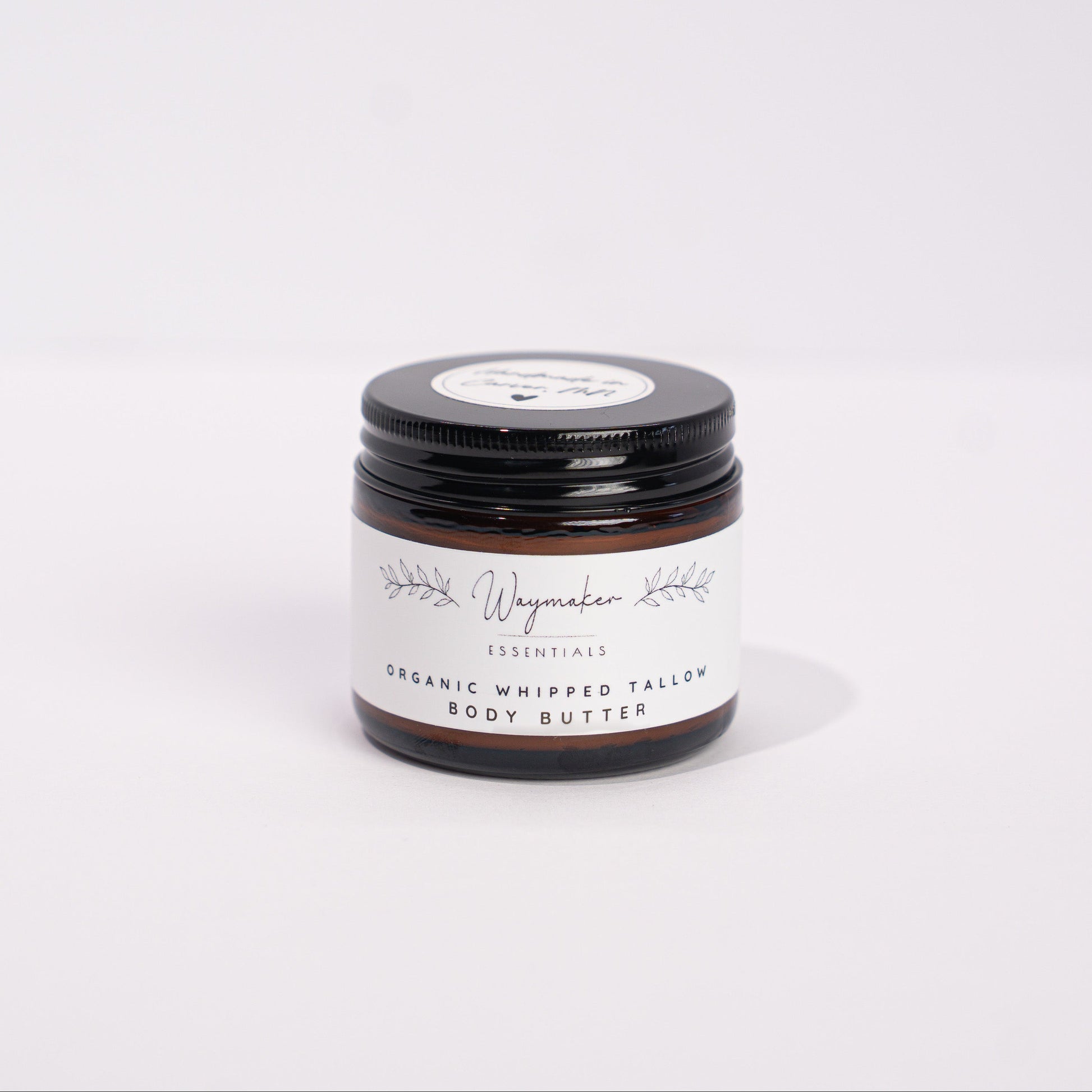 Small jar of organic whipped cream on a white background